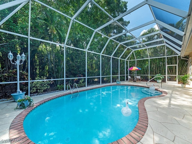 view of swimming pool featuring a lanai and a patio area