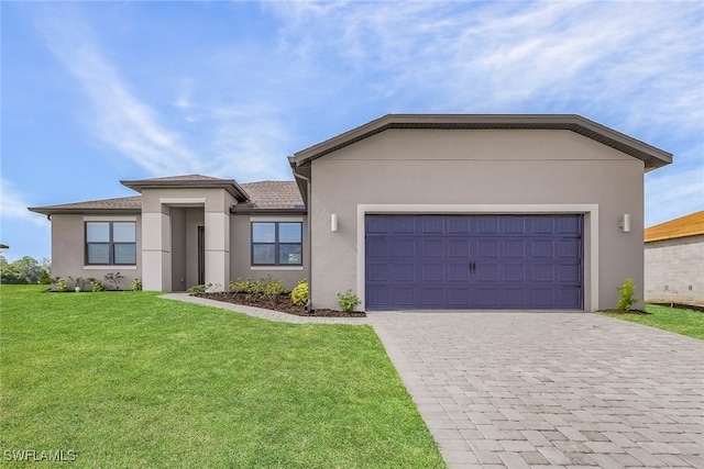 view of front of home with a garage, a front yard, decorative driveway, and stucco siding