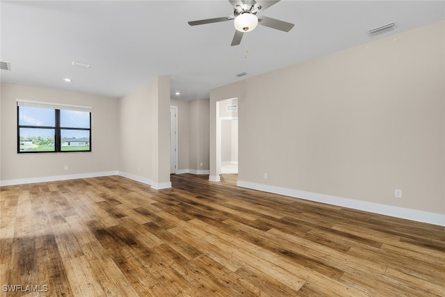 empty room with hardwood / wood-style flooring and ceiling fan