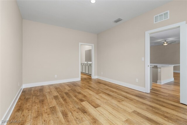 spare room with ceiling fan and light hardwood / wood-style flooring