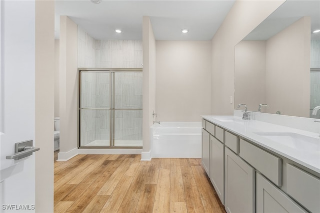 full bathroom featuring vanity, toilet, independent shower and bath, and hardwood / wood-style flooring