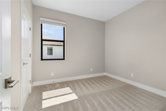 unfurnished room featuring light carpet