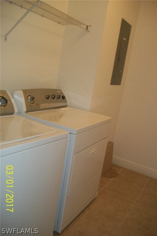 washroom with separate washer and dryer, electric panel, and light tile patterned floors