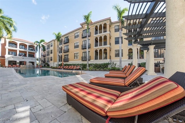 view of pool with a pergola and a patio