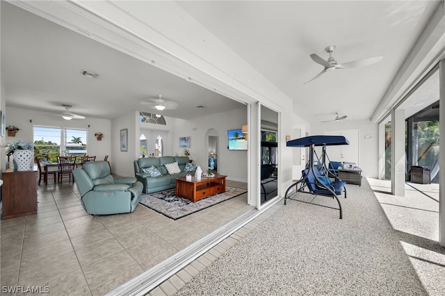 living room with ceiling fan and light tile floors