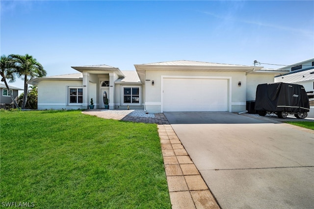 view of front of house with a front yard and a garage