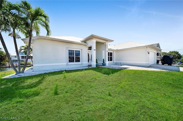 view of front of property with a garage and a front yard