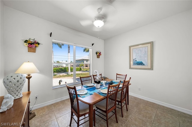 tiled dining space with ceiling fan