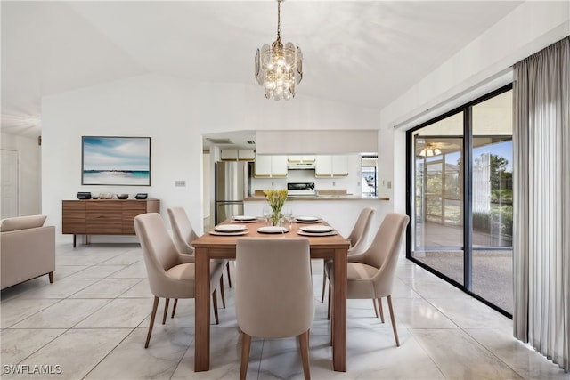 tiled dining area with vaulted ceiling and an inviting chandelier