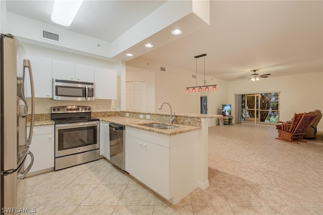 kitchen with ceiling fan, stainless steel appliances, kitchen peninsula, and sink