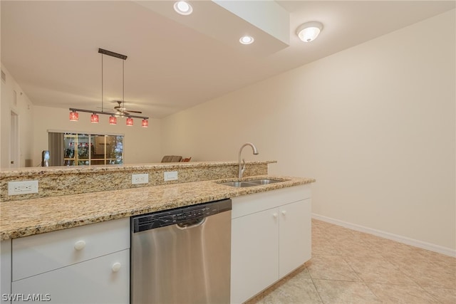 kitchen with stainless steel dishwasher, white cabinets, light stone counters, sink, and ceiling fan