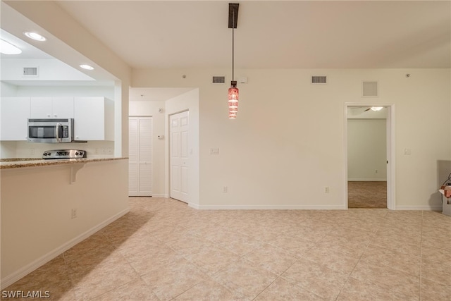 unfurnished living room featuring light tile floors