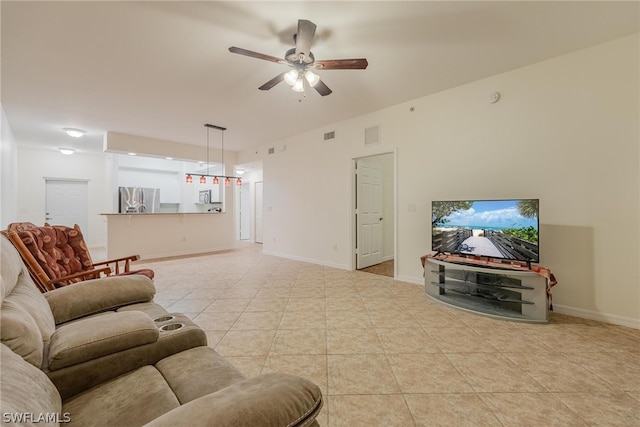 tiled living room with ceiling fan