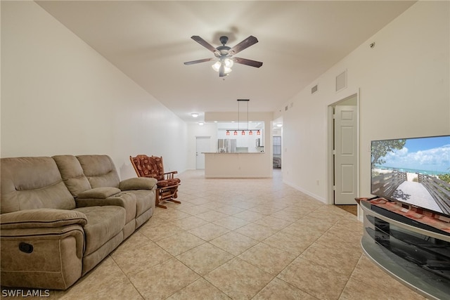 tiled living room featuring ceiling fan