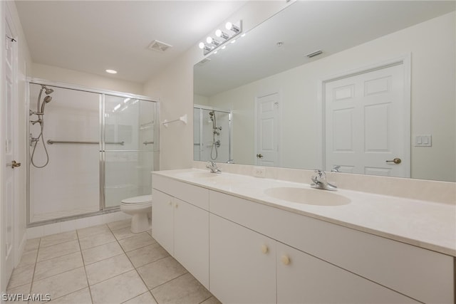 bathroom featuring toilet, tile flooring, an enclosed shower, large vanity, and double sink