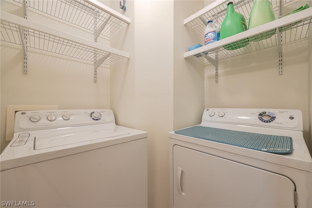 washroom featuring washer and clothes dryer