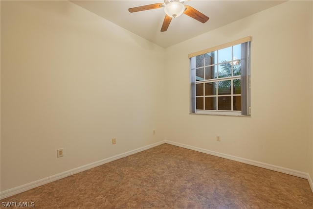 tiled empty room featuring ceiling fan