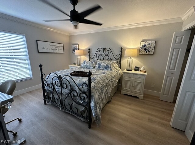 bedroom featuring ornamental molding, hardwood / wood-style flooring, and ceiling fan