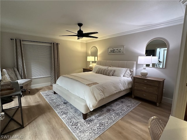 bedroom featuring hardwood / wood-style floors, ceiling fan, and crown molding