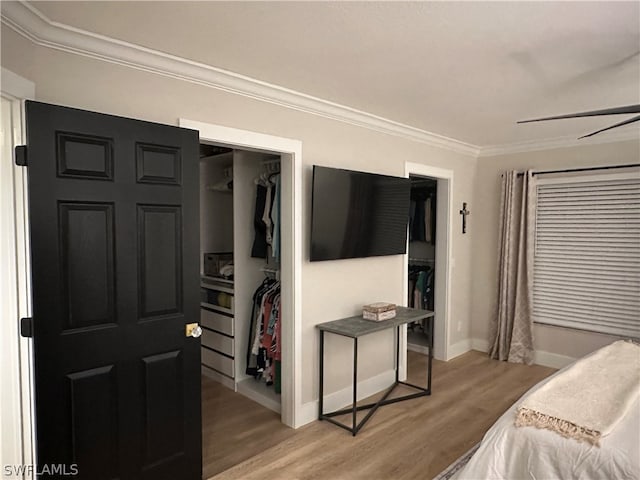 bedroom featuring ornamental molding, hardwood / wood-style flooring, and a closet