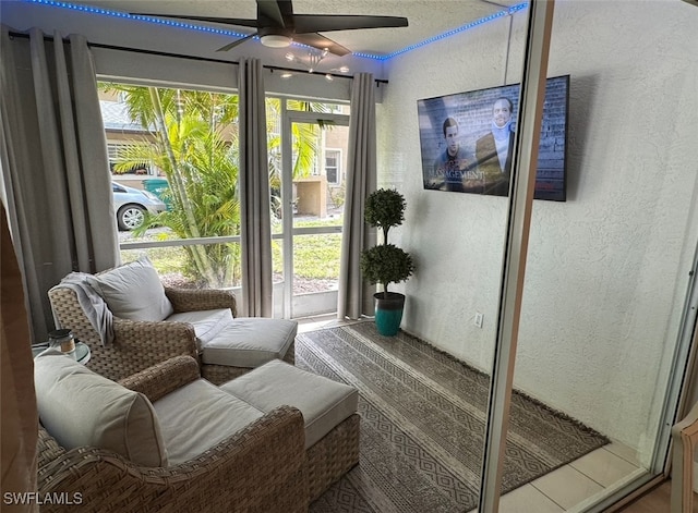 sunroom featuring a wealth of natural light and ceiling fan