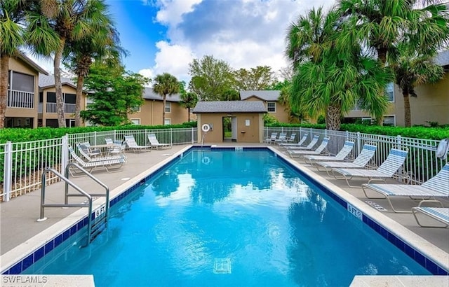 view of swimming pool featuring an outdoor structure and a patio area