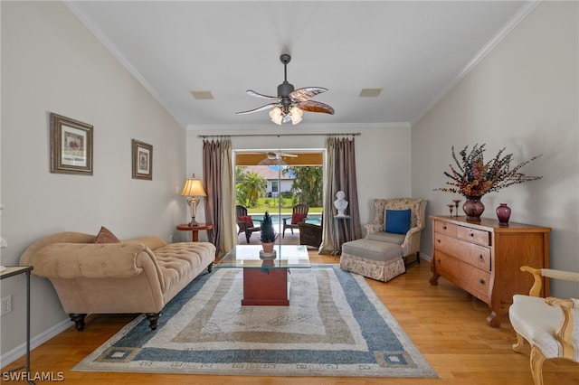 living room with ornamental molding, ceiling fan, and light hardwood / wood-style flooring