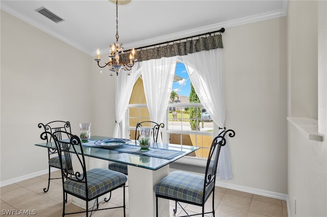 dining room with crown molding, light tile floors, and an inviting chandelier