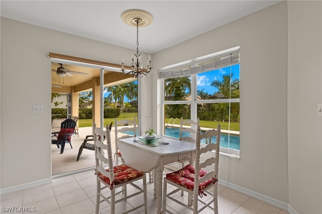 dining room with light tile flooring and ceiling fan with notable chandelier