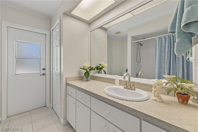 bathroom with oversized vanity, ornamental molding, and tile floors