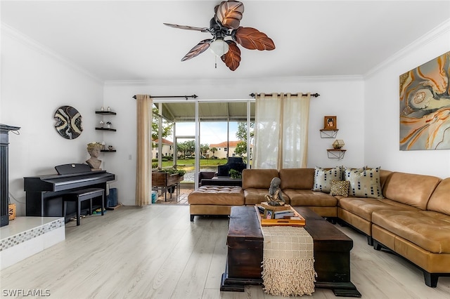 living room with hardwood / wood-style flooring, ornamental molding, and ceiling fan