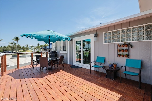 wooden terrace featuring outdoor dining space