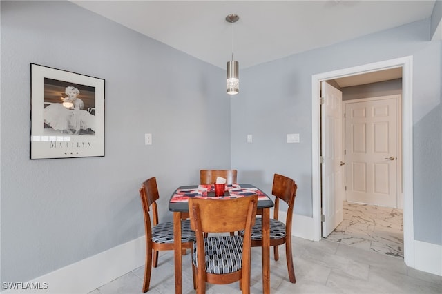 dining room featuring marble finish floor and baseboards