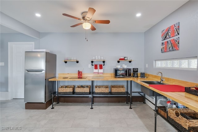 kitchen with ceiling fan, stainless steel appliances, and recessed lighting