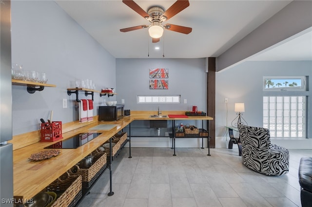 interior space featuring recessed lighting, open shelves, a sink, a ceiling fan, and black appliances