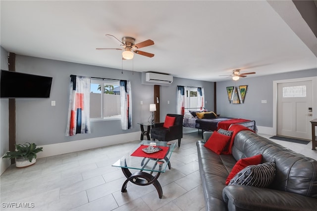 living room featuring a wall mounted AC, tile patterned flooring, a ceiling fan, and baseboards