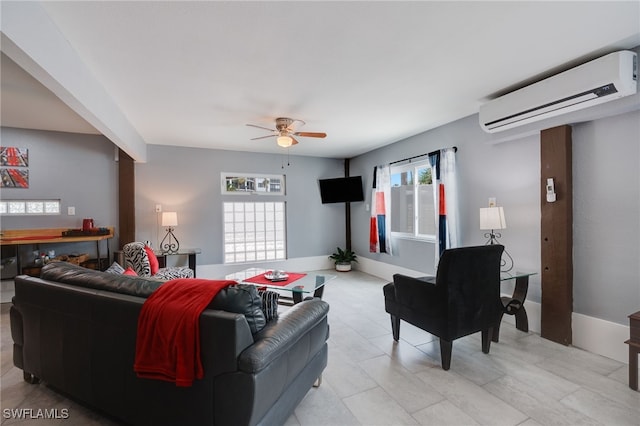 living room with a wall unit AC, ceiling fan, and baseboards