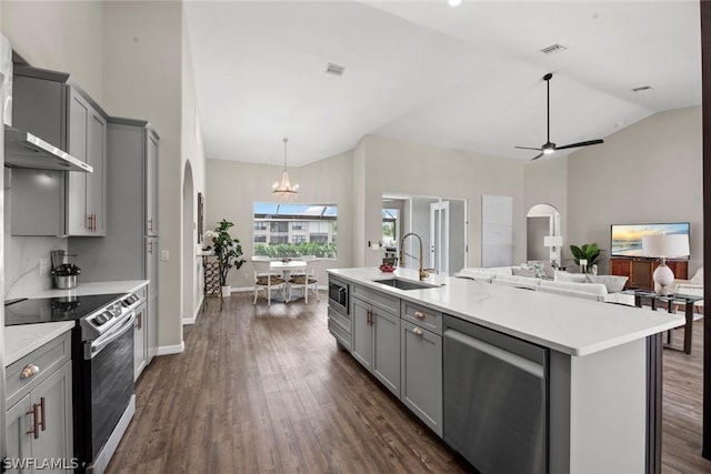 kitchen with sink, dark hardwood / wood-style flooring, gray cabinets, ceiling fan with notable chandelier, and appliances with stainless steel finishes