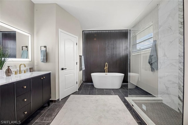 bathroom with vanity, independent shower and bath, and vaulted ceiling