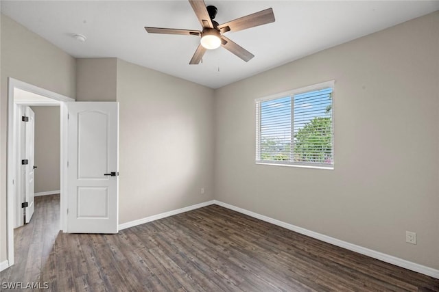 unfurnished room featuring ceiling fan and dark hardwood / wood-style floors