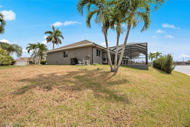 view of yard with a lanai and central AC