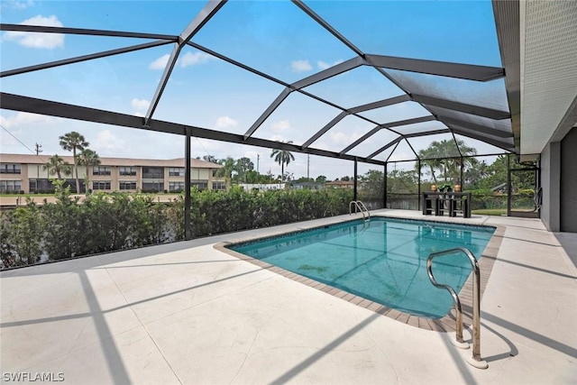 view of swimming pool featuring a patio and glass enclosure