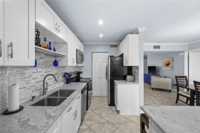 kitchen featuring light stone counters, white cabinets, electric range, and sink