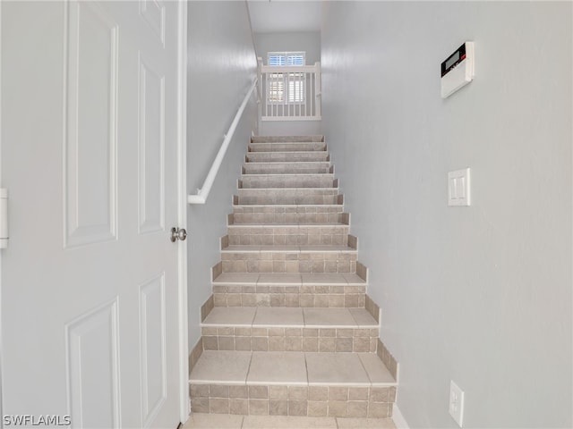 stairway featuring tile patterned floors