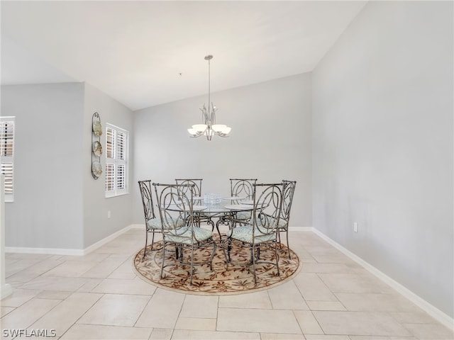 tiled dining room featuring a chandelier and vaulted ceiling