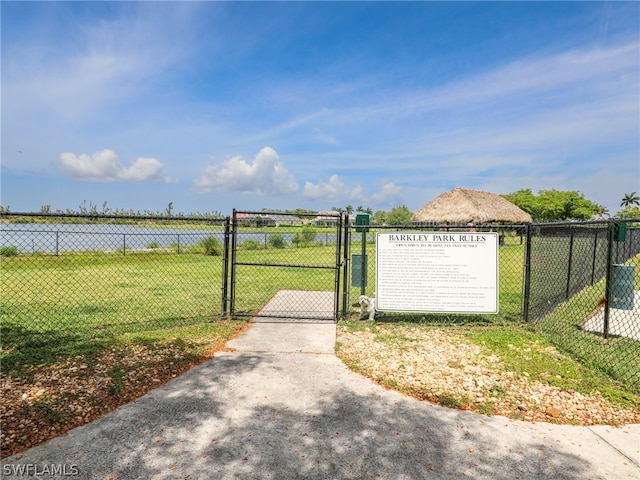 view of gate featuring a yard