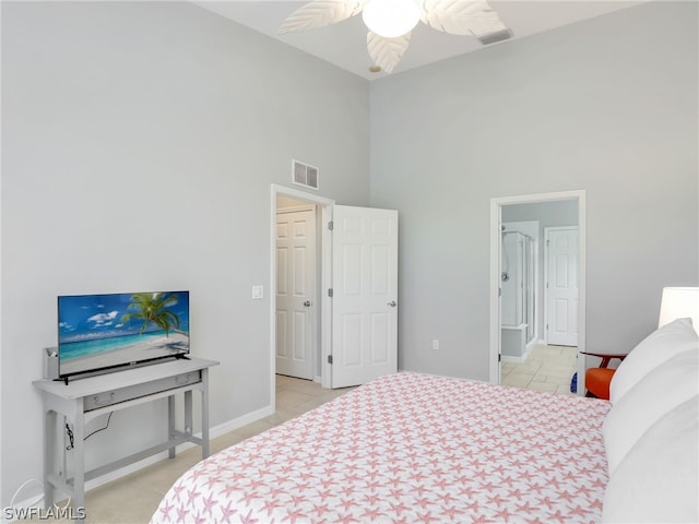 bedroom featuring light tile patterned floors, a towering ceiling, and ceiling fan