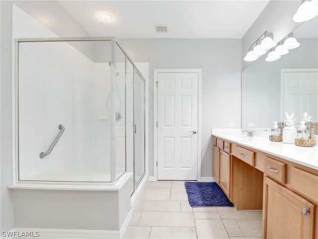 bathroom featuring tile patterned flooring, vanity, and an enclosed shower