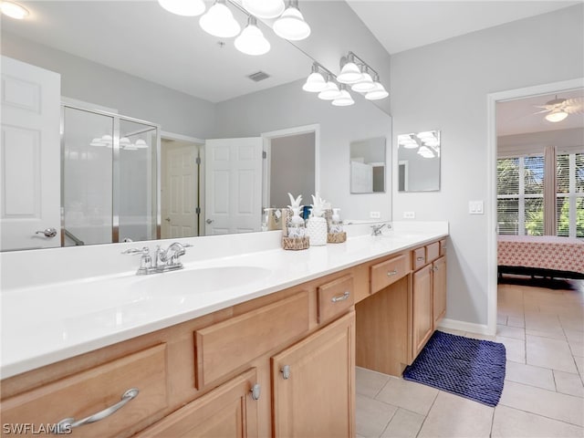 bathroom with ceiling fan, tile patterned flooring, vanity, and a shower with shower door