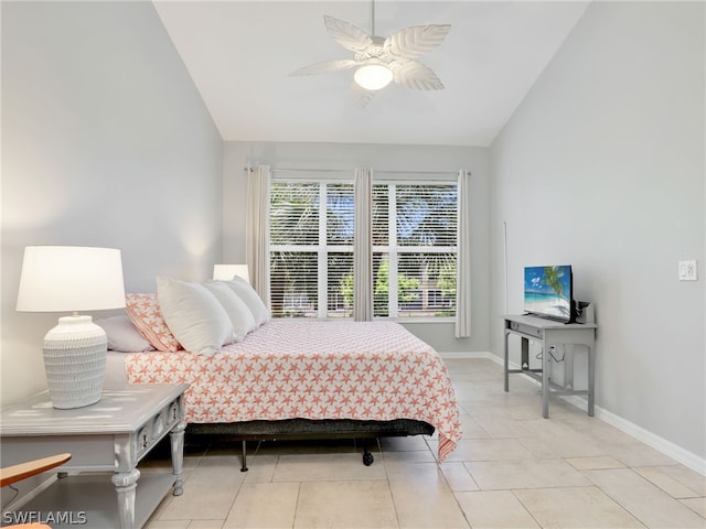 bedroom featuring ceiling fan, light tile patterned floors, and lofted ceiling